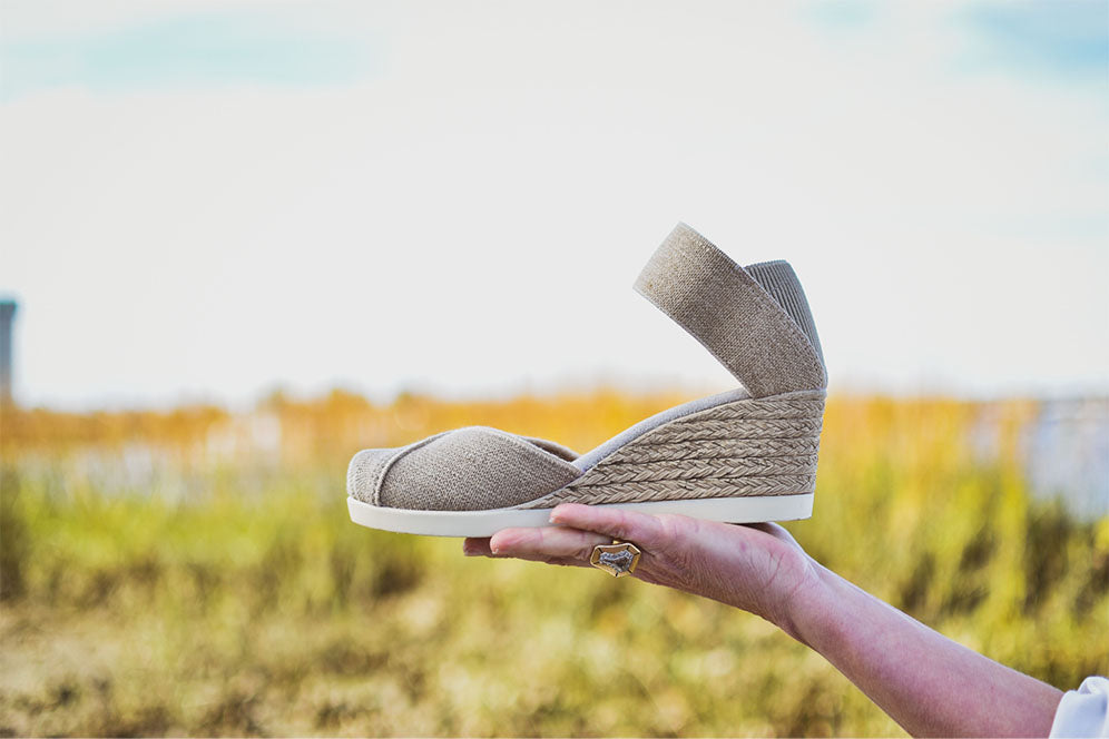 holding wedge shoe in hand